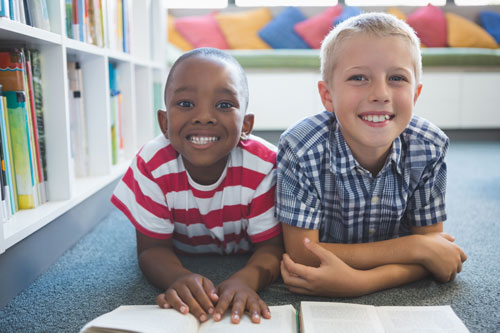 Smiling Kids in Library on Floor